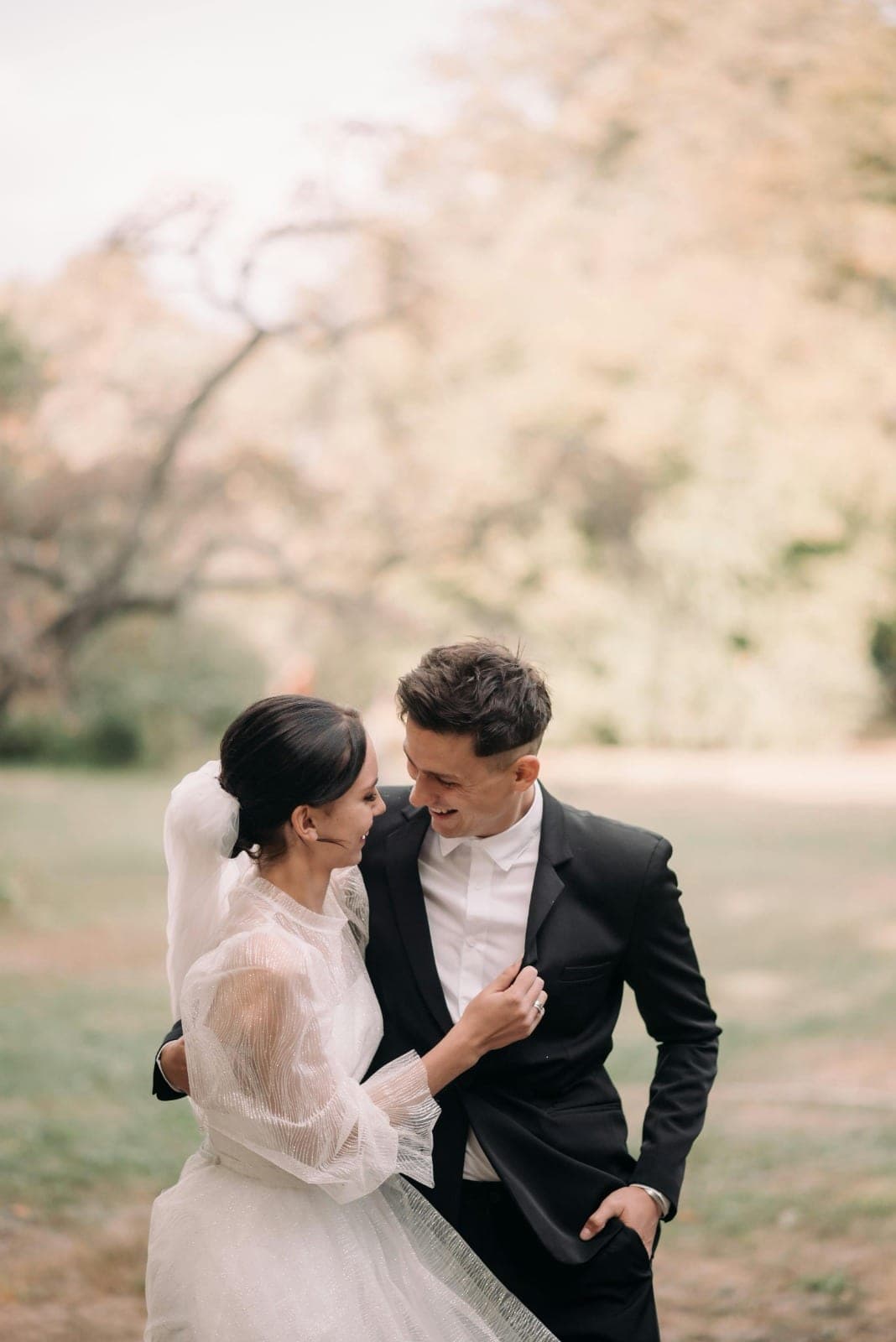 A couple sharing a quiet moment beneath blossom trees
