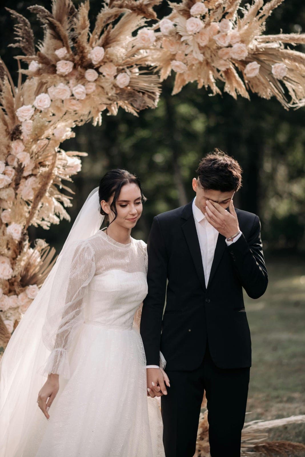 An emotional moment between the couple at the ceremony arch