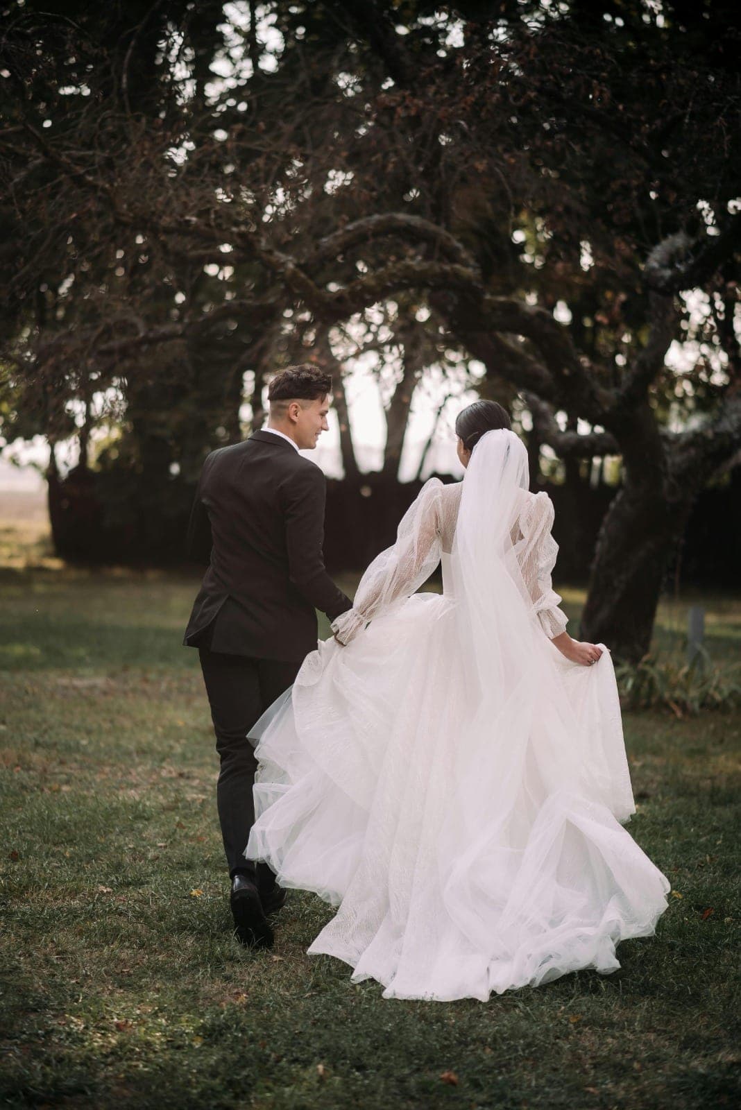 The couple walking together through the gardens