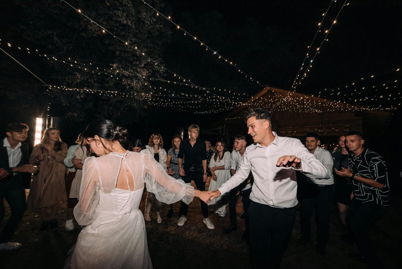 The first dance under a canopy of string lights