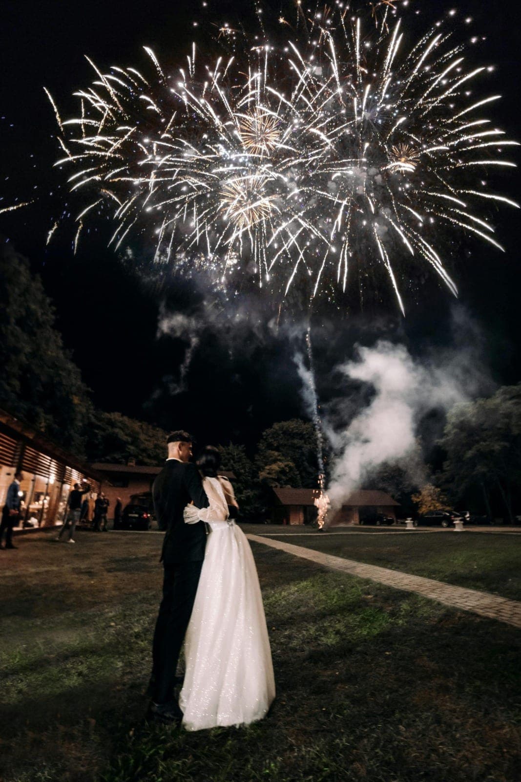 Guests gathered under string lights at night