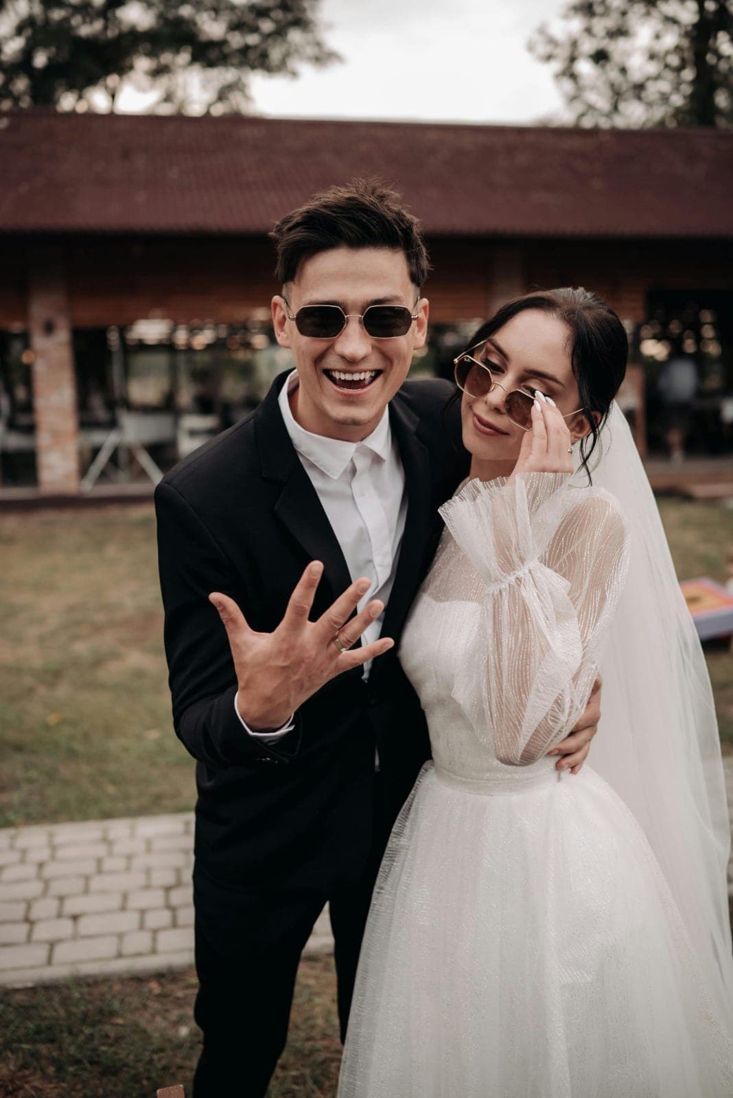 The couple laughing together outside the reception